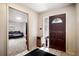 Inviting entryway featuring a decorative wood door and tile flooring, leading to a comfortable living space at 5030 Alderman Rd, Lakeland, FL 33810