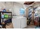 Laundry room with washer, dryer, and shelving unit at 5030 Alderman Rd, Lakeland, FL 33810