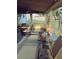 Screened porch featuring neutral carpeting, a ceiling fan, and outdoor furniture, perfect for relaxing outdoors at 5030 Alderman Rd, Lakeland, FL 33810