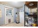 Practical utility room with checkered walls, including a water heater and shelving at 5030 Alderman Rd, Lakeland, FL 33810