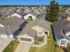 One-story house with grey roof and landscaped yard in a community at 152 Travis Ln, Davenport, FL 33837
