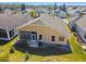 Aerial view of house showcasing backyard patio and surrounding landscape at 152 Travis Ln, Davenport, FL 33837