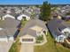 One-story house with grey roof and landscaped yard in a community at 152 Travis Ln, Davenport, FL 33837