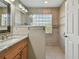Bathroom with double vanity, granite countertop and walk-in shower at 152 Travis Ln, Davenport, FL 33837