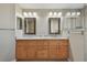 Double vanity bathroom with granite countertops and large mirrors at 152 Travis Ln, Davenport, FL 33837