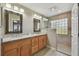 Double vanity bathroom with granite countertops and walk-in shower at 152 Travis Ln, Davenport, FL 33837