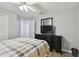Bedroom with full-size bed, dresser, and ceiling fan at 152 Travis Ln, Davenport, FL 33837