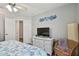 Bedroom with king-size bed, white dresser, and ceiling fan at 152 Travis Ln, Davenport, FL 33837