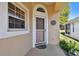 Front door entrance with a screen door and a clock at 152 Travis Ln, Davenport, FL 33837