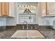 Double kitchen sink with granite countertop at 152 Travis Ln, Davenport, FL 33837