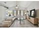 Relaxing living room featuring a sectional sofa and large TV at 152 Travis Ln, Davenport, FL 33837