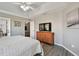Main bedroom with dresser, king bed and access to another room at 152 Travis Ln, Davenport, FL 33837