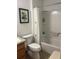 Standard bathroom featuring toilet, wood vanity, and combination tub and shower at 2595 Edenville Path, The Villages, FL 32162