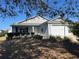Charming one-story home with a well-maintained yard, featuring a 2-car garage and cozy front porch at 2595 Edenville Path, The Villages, FL 32162