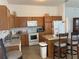 Functional kitchen with a convenient island bar with counter seating and plenty of cabinet space at 2595 Edenville Path, The Villages, FL 32162