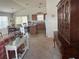 View of the living room showcasing an open layout with an adjacent dining area and functional kitchen at 2595 Edenville Path, The Villages, FL 32162