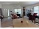 Inviting living room with neutral carpet, ceiling fan, and comfortable seating arrangements at 2595 Edenville Path, The Villages, FL 32162