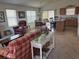 Bright living room featuring neutral carpet, a comfortable seating arrangement, and an open layout at 2595 Edenville Path, The Villages, FL 32162