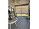 Screened porch with white furniture and view of the backyard at 2595 Edenville Path, The Villages, FL 32162