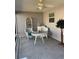 Enclosed porch features seating and table with ceiling fan at 2595 Edenville Path, The Villages, FL 32162
