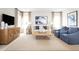 Bright living room featuring neutral tones, stylish furniture, and a large abstract painting for a welcoming atmosphere at 5008 Balsam Falls Rd, Deland, FL 32724
