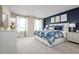 Main bedroom with blue and white bedding and large windows at 5012 Balsam Falls Rd, Deland, FL 32724