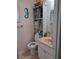 Small bathroom with a toilet, sink, and shelving at 11301 Huggins St, Leesburg, FL 34788