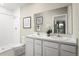 Double vanity bathroom with white cabinets and a shower at 1530 Landon Ln, Haines City, FL 33844