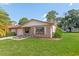 Front view of a brick ranch home with a well-manicured lawn at 801 Egret Ct, Edgewater, FL 32141