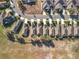 This aerial view captures a residential street lined with houses, featuring mature trees and well-kept yards in a quiet setting at 22004 Belgian Ct, Mount Dora, FL 32757