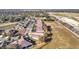 This aerial showcases a suburban neighborhood, displaying a well-maintained community with neat rows of houses and ample green spaces at 22004 Belgian Ct, Mount Dora, FL 32757