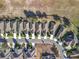 A bird's eye view presents homes with landscaped yards along a winding street, bordered by a field and a rustic wooden fence at 22004 Belgian Ct, Mount Dora, FL 32757