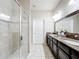 Modern bathroom featuring glass enclosed tiled shower, tiled floor, and double vanity at 22004 Belgian Ct, Mount Dora, FL 32757