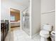 A well lit bathroom with a glass shower and view to the bedroom at 22004 Belgian Ct, Mount Dora, FL 32757