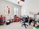 Bedroom featuring shuttered windows, a ceiling fan and an abstract art piece at 22004 Belgian Ct, Mount Dora, FL 32757