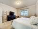 A well-lit bedroom features soft colors, and a mounted flatscreen TV above a dark wood dresser at 22004 Belgian Ct, Mount Dora, FL 32757