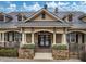 Community clubhouse featuring stone accents, a covered porch, and beautifully landscaped entrance at 22004 Belgian Ct, Mount Dora, FL 32757