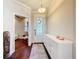 Bright foyer with a decorative glass front door, a white console table, and hardwood flooring at 22004 Belgian Ct, Mount Dora, FL 32757