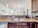 Kitchen sink overlooks open floor plan with granite countertops and stainless steel appliances at 22004 Belgian Ct, Mount Dora, FL 32757