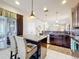 Open kitchen features stainless appliances, granite countertops, a center island, and backyard access at 22004 Belgian Ct, Mount Dora, FL 32757