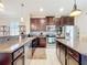 Kitchen showcases stainless appliances, granite countertops, a center island, and dark wood cabinetry at 22004 Belgian Ct, Mount Dora, FL 32757