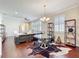 Dining area and living room with hardwood floors, ceiling fan, and white plantation shutters at 22004 Belgian Ct, Mount Dora, FL 32757