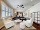 Open floor plan with dark hardwood floors, plantation shutters, and modern furniture at 22004 Belgian Ct, Mount Dora, FL 32757