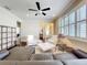 Bright living room features a ceiling fan, stylish furniture, and hardwood floors at 22004 Belgian Ct, Mount Dora, FL 32757