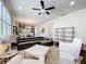 Open concept living room featuring dark hardwood floors, white sofas, and modern furnishings at 22004 Belgian Ct, Mount Dora, FL 32757