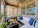 Inviting screened-in patio with cozy seating area, decorative pillows, and ample sunlight for relaxation at 22004 Belgian Ct, Mount Dora, FL 32757