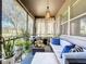 Relaxing screened-in patio features comfortable seating, stylish decor, and a serene view of the surrounding landscape at 22004 Belgian Ct, Mount Dora, FL 32757