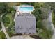 Aerial perspective of a community pool area with a clubhouse, meticulously landscaped grounds, and ample seating for residents at 22004 Belgian Ct, Mount Dora, FL 32757