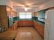 Well-lit kitchen featuring ample counter space, retro cabinets, and natural lighting at 3621 Conine E Dr, Winter Haven, FL 33881