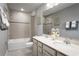 Bathroom with double vanity, tub shower combo, and tile flooring at 7405 Sw 108Th St, Ocala, FL 34476